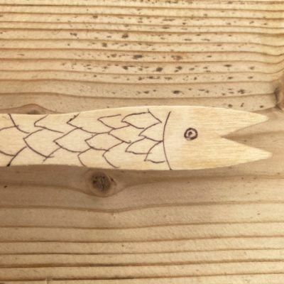 A chip fork fish, made by drawing on a wooden chip fork