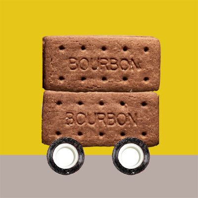 Photomontage of double decker bus made from two bourbon biscuits and rolls of tape as wheels