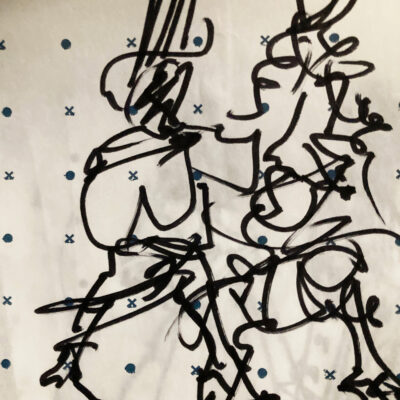 Sketch of two models on the runway, drawn on pattern paper printed with dots and crosses