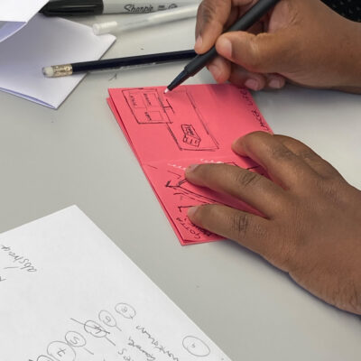 Workshop participant drawing the 'reveal' in the middle of her zine