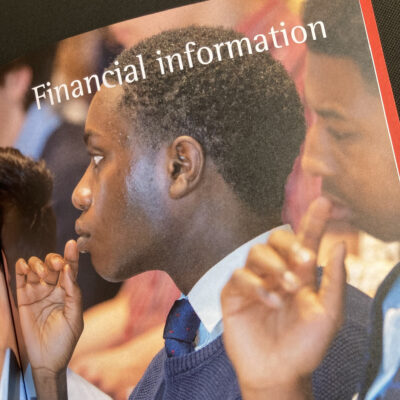 Detail of finance divider spread showing business school students listening