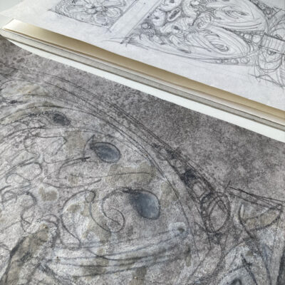 Wallpaper drawing in progress next to sketchbook