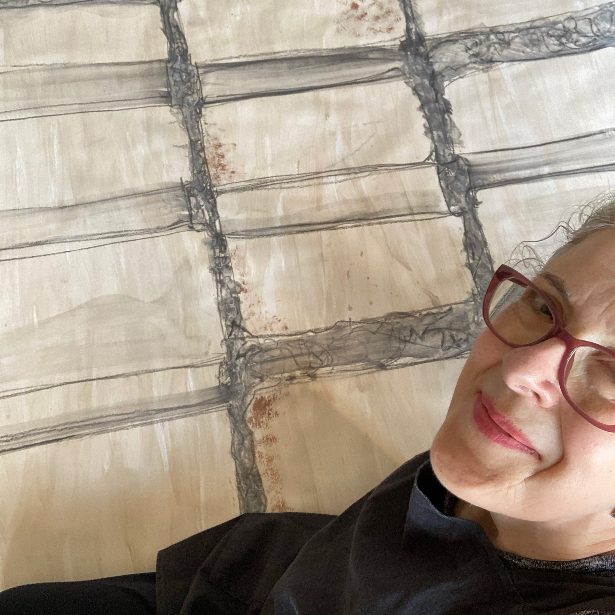 Lydia sitting on the floor with the biggest drawing she's ever done