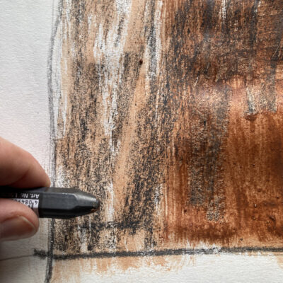 Lydia's hand with graphite stick, drawing a brick detail