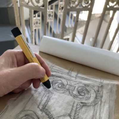 Lydia's hand drawing metalwork detail in builder's wax