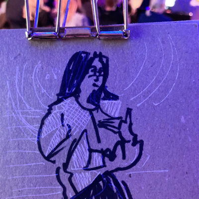 Jieling Xiao speaking, drawing in black and white line on brown packing board