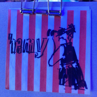 Photographer Aleks in action, drawn on striped paper from paper bag