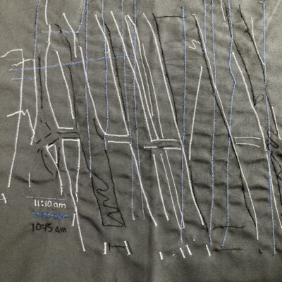Textile shadow tracing with lines colour coded for time and embroidered time notes, dark beckground